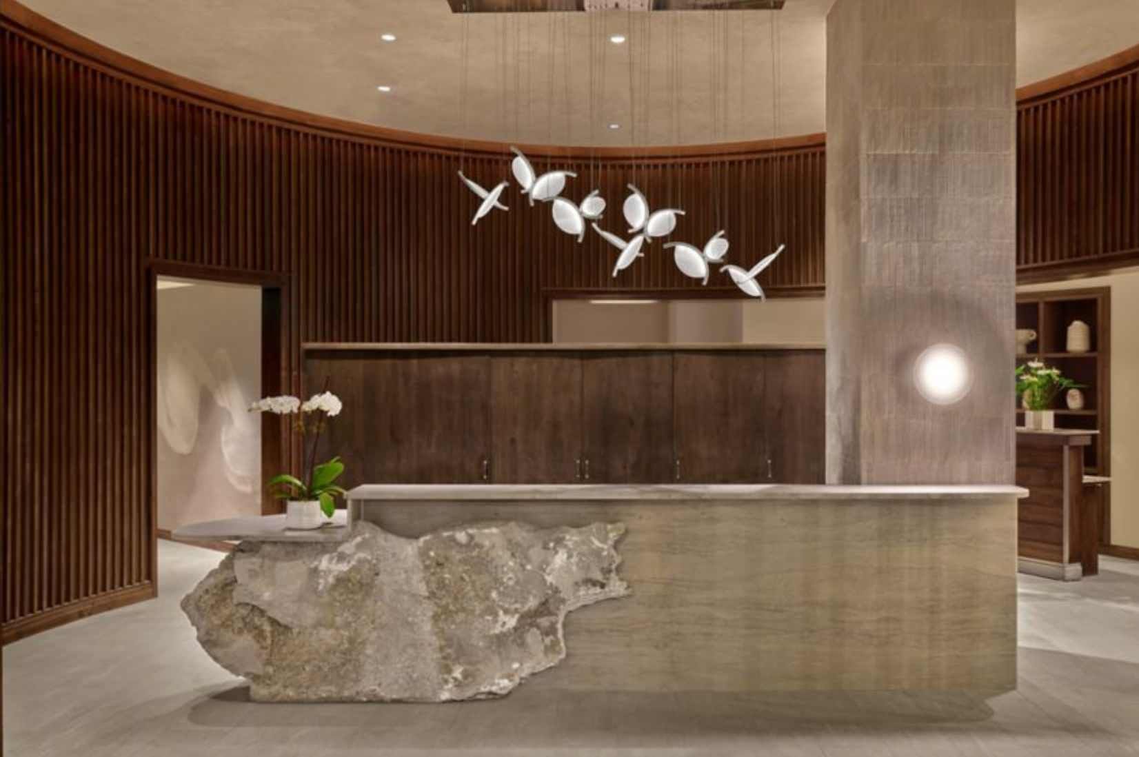 There is a large stone counter in the middle of the room.