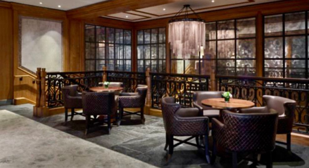 A room with tables and chairs in it and a chandelier.
