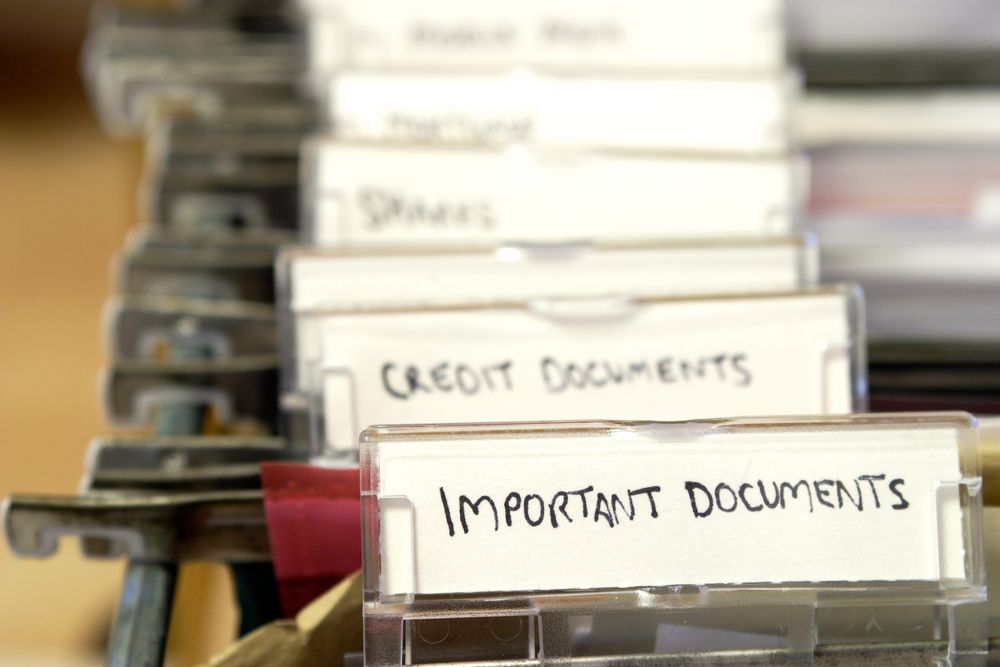 A close-up of hanging file folders in a drawer, with a foreground tab labeled 