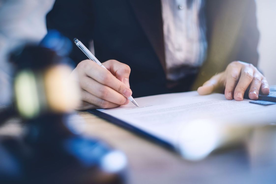 lawyer sitting working desk hand holding