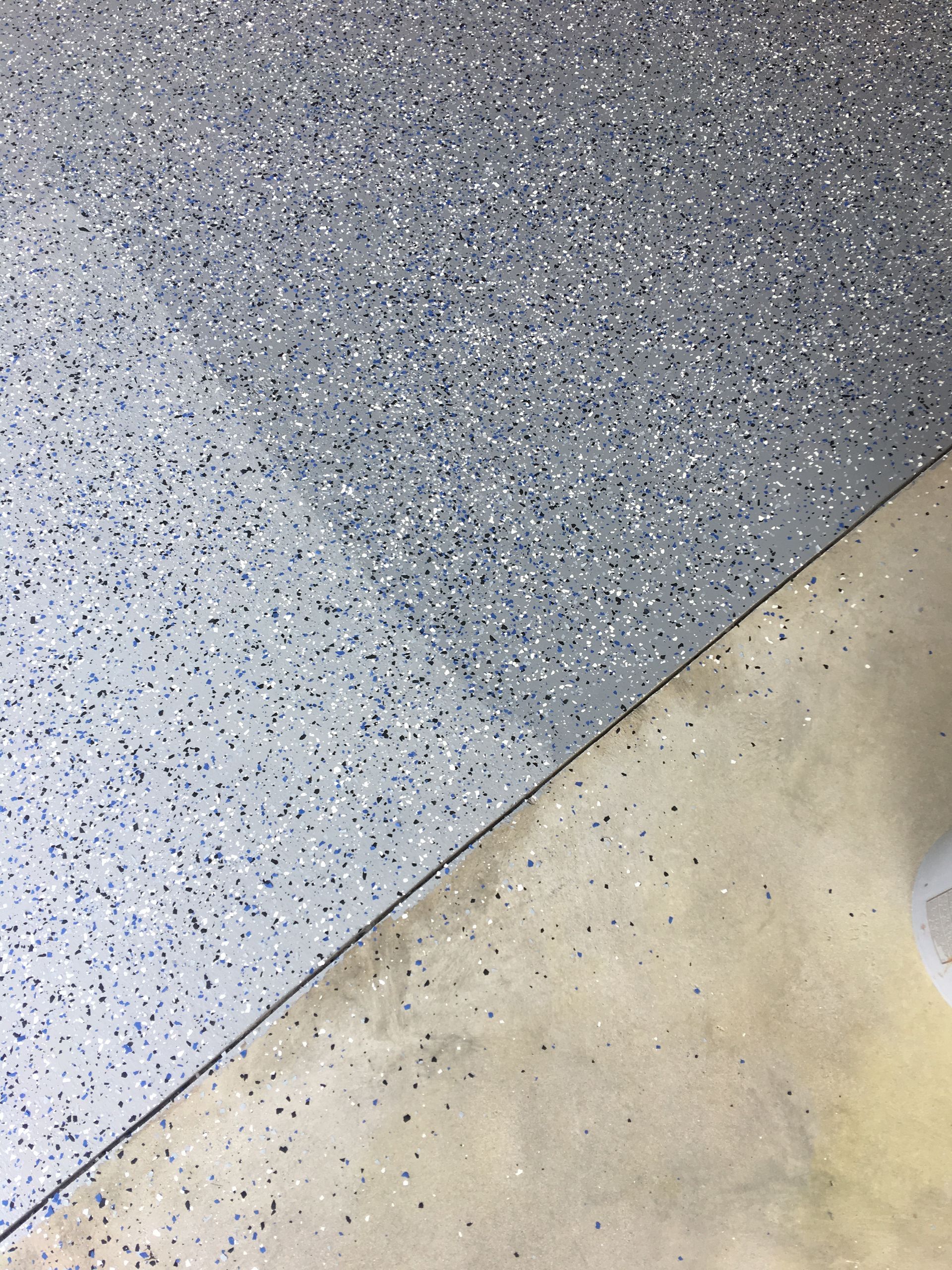A close up of a gray and white tile floor.