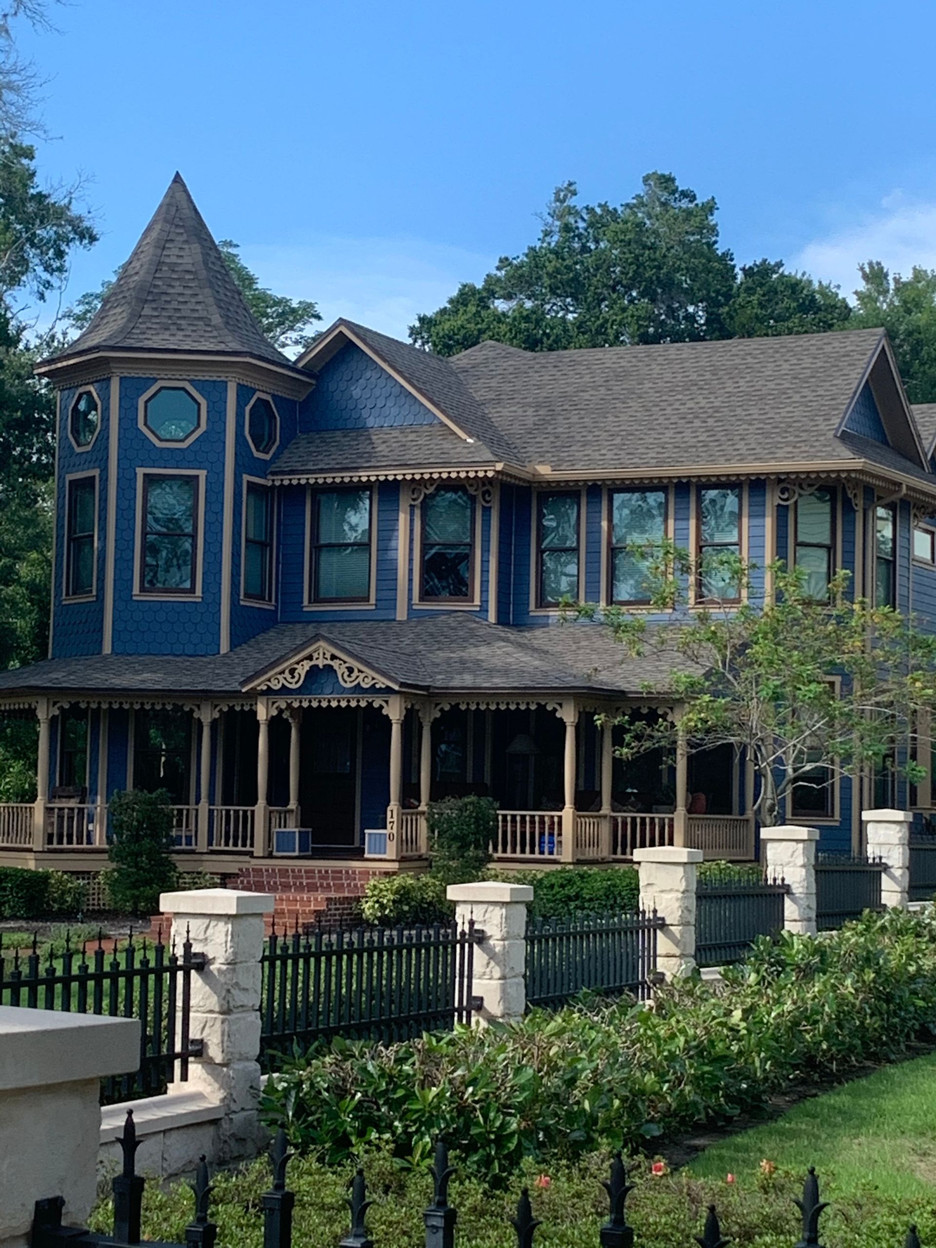 A large blue house with a tower on top of it