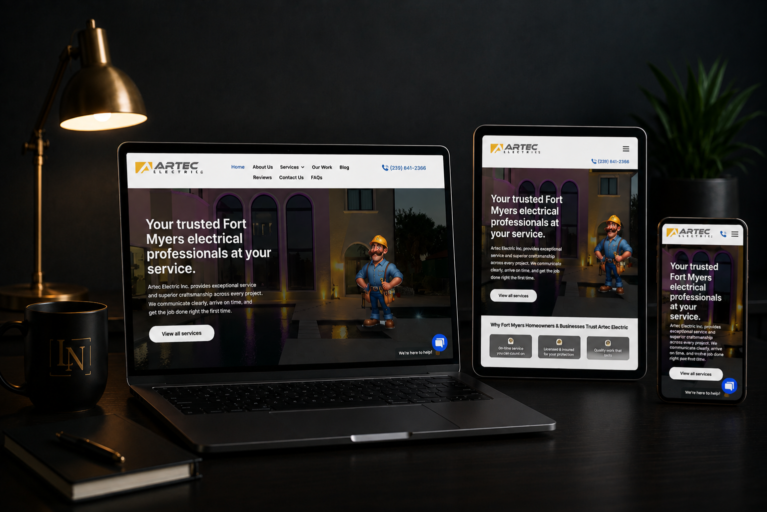 Responsive website displayed on laptop, tablet, and phone in a dimly lit desk setup