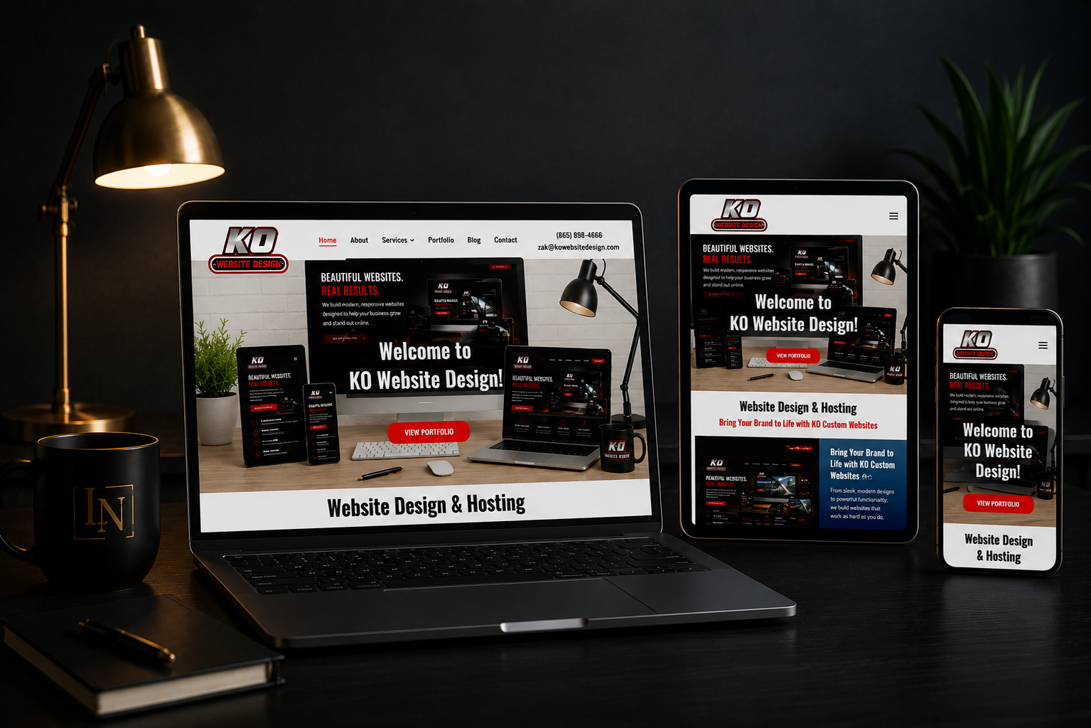 Laptop, tablet, and phone display a dark-themed website on a desk with a lamp and plant.