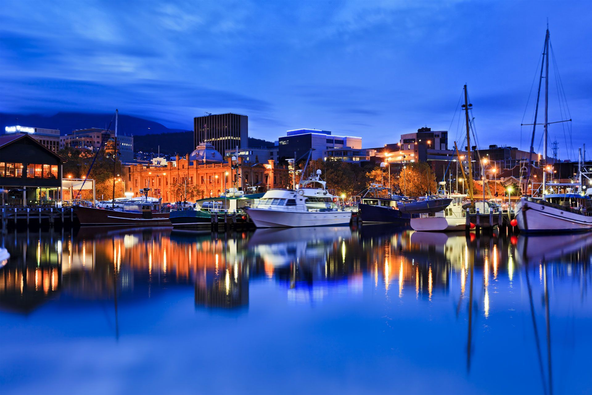Harbour scene at dusk, boats docked, city lights reflecting on the water — Industrial Automation Australia in Eagle Farm, QLD