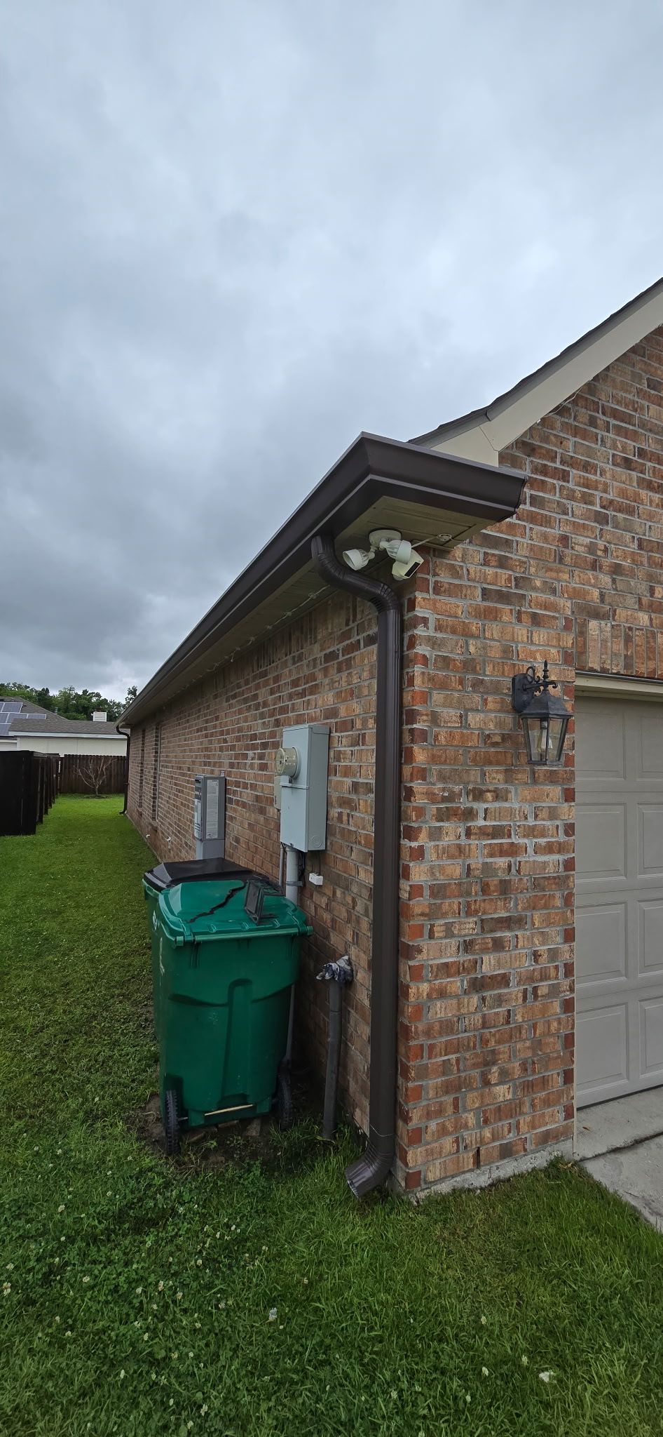 Downspout installed on exterior wall