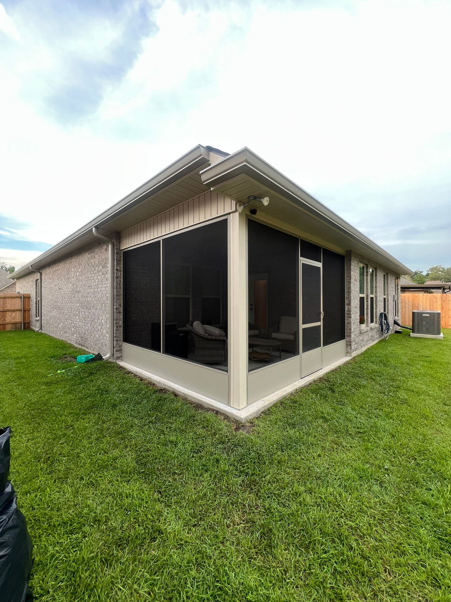 Outdoor screened room attached to house