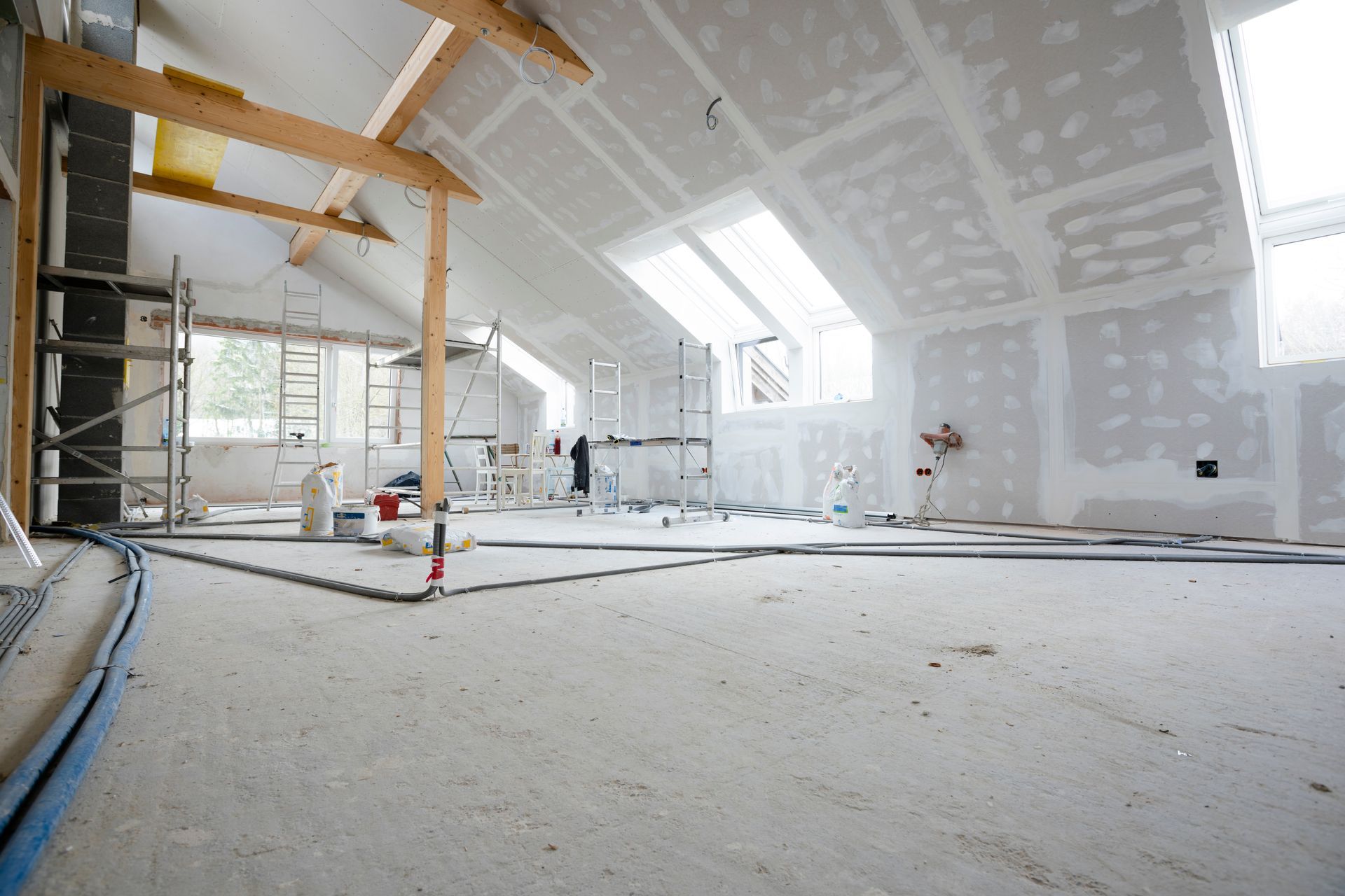 Attic finishing construction site in the phase drywall spackling and plastering before screeding.