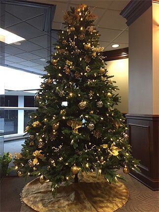 Decorated Christmas tree with warm white lights in an office lobby