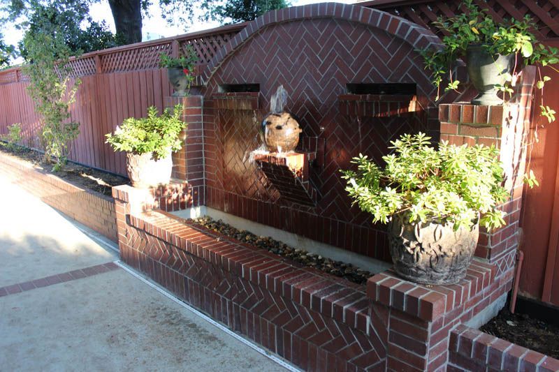 A brick wall with a waterfall in the middle of it