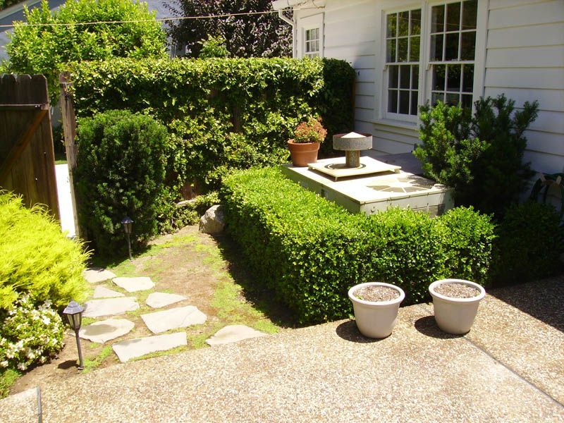 A white house with a garden in front of it