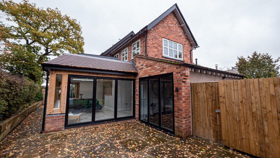 Rear exterior of single-storey extension by Rawlinson Construction, with large glazing