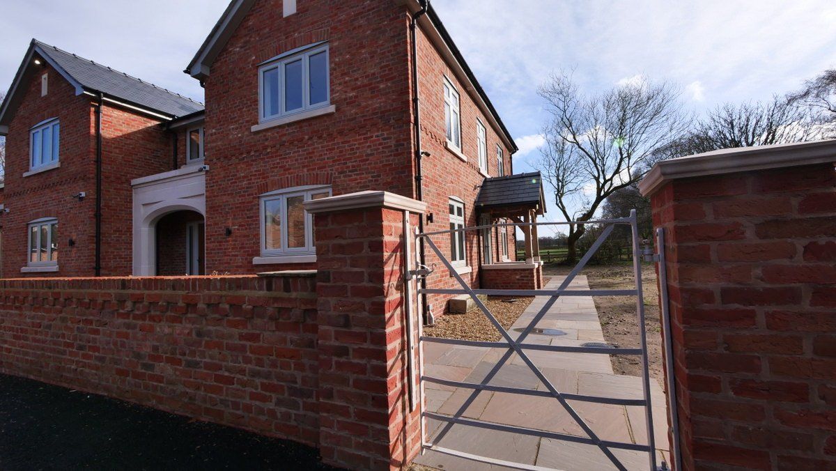 Exterior view of newly constructed farmhouse family home, Cheshire