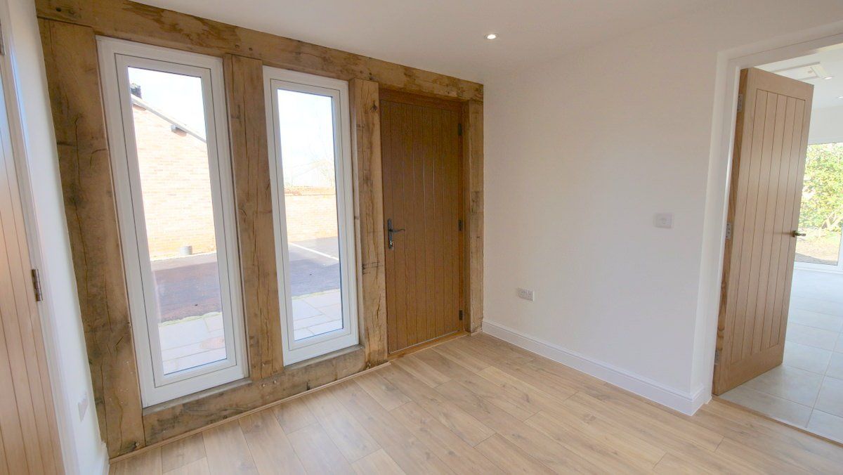 Entrance hall of new build property in Cheshire featuring exposed timber frame and natural light