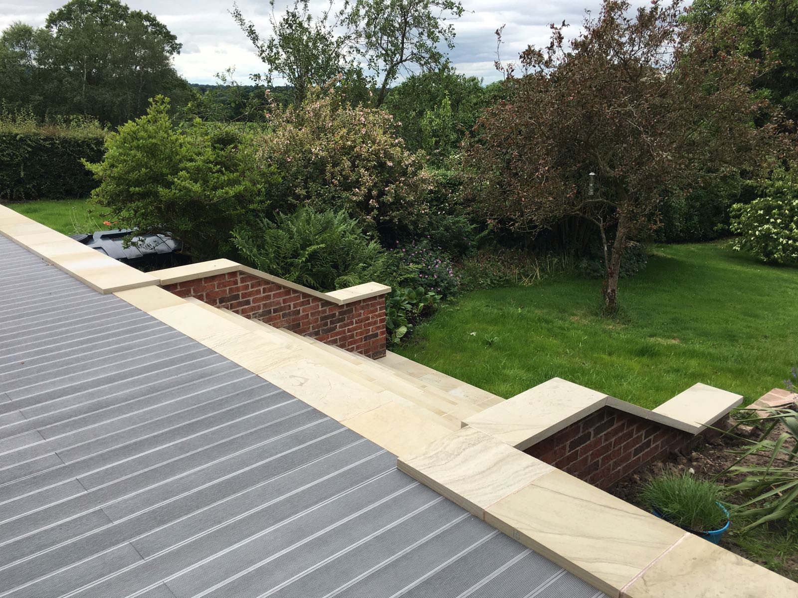 Landscaped gardens surrounding Cheshire home with oak frame extension constructed by Rawlinson Construction