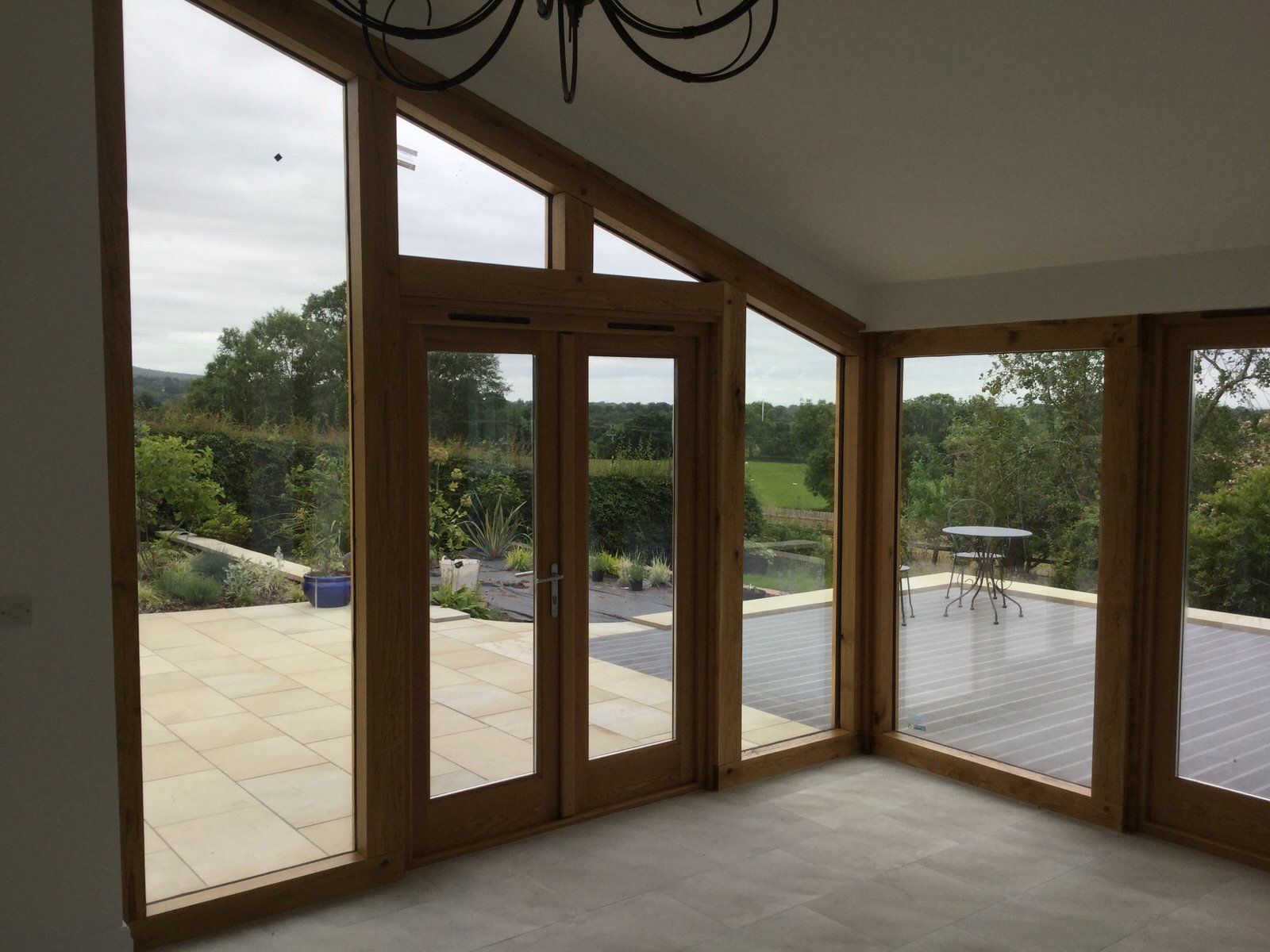 Oak-framed garden room connecting indoor living space to landscaped outdoor area in Cheshire