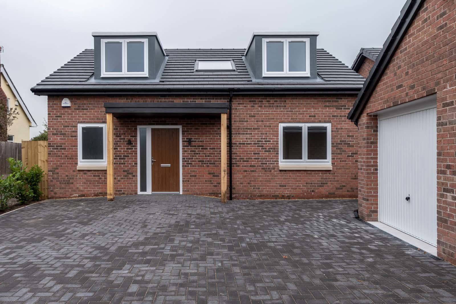 Front view of contemporary dormer bungalow in Cheshire built by Rawlinson Construction with modern façade