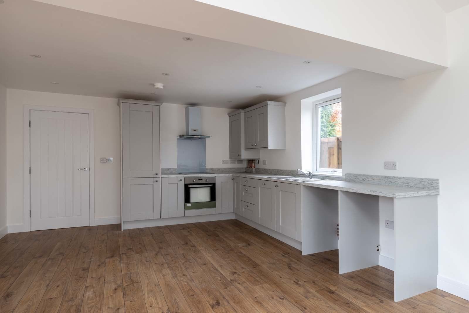 Modern kitchen in newly built dormer bungalow featuring contemporary finishes