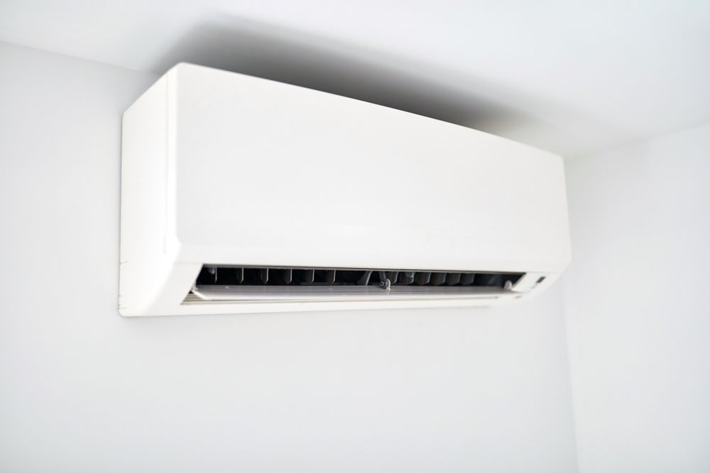 A white wall-mounted air conditioning unit installed on a plain white wall. — Unger Air in South Tamworth, NSW
