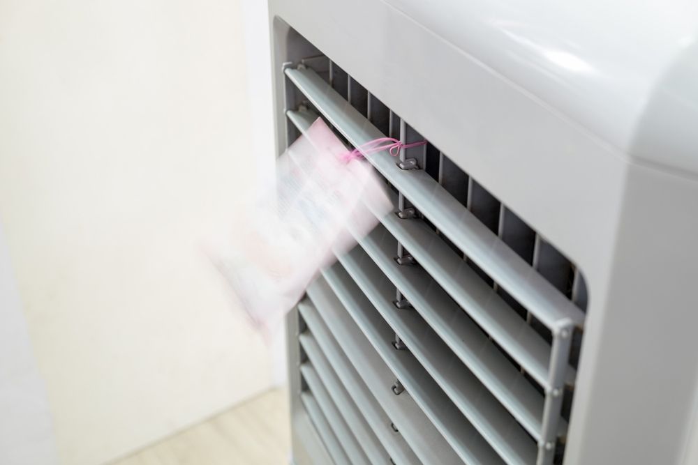 A Close Up of a White Air Conditioner With a Pink Sticker on It — Unger Air in South Tamworth, NSW