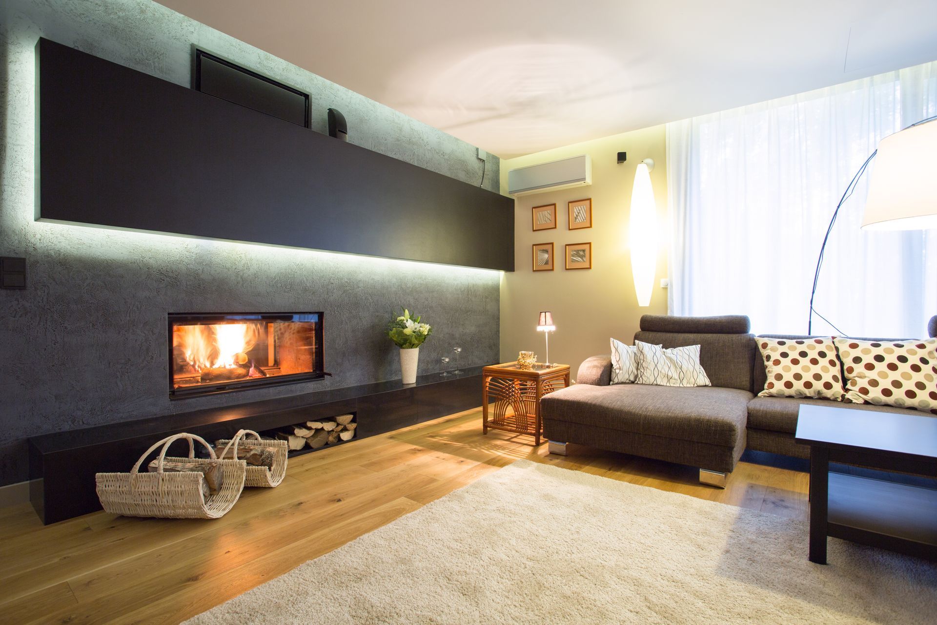 A Modern Living Room With a Fireplace, a Long Shelf, a Couch With Patterned Pillows — Unger Air in Gunnedah, NSW