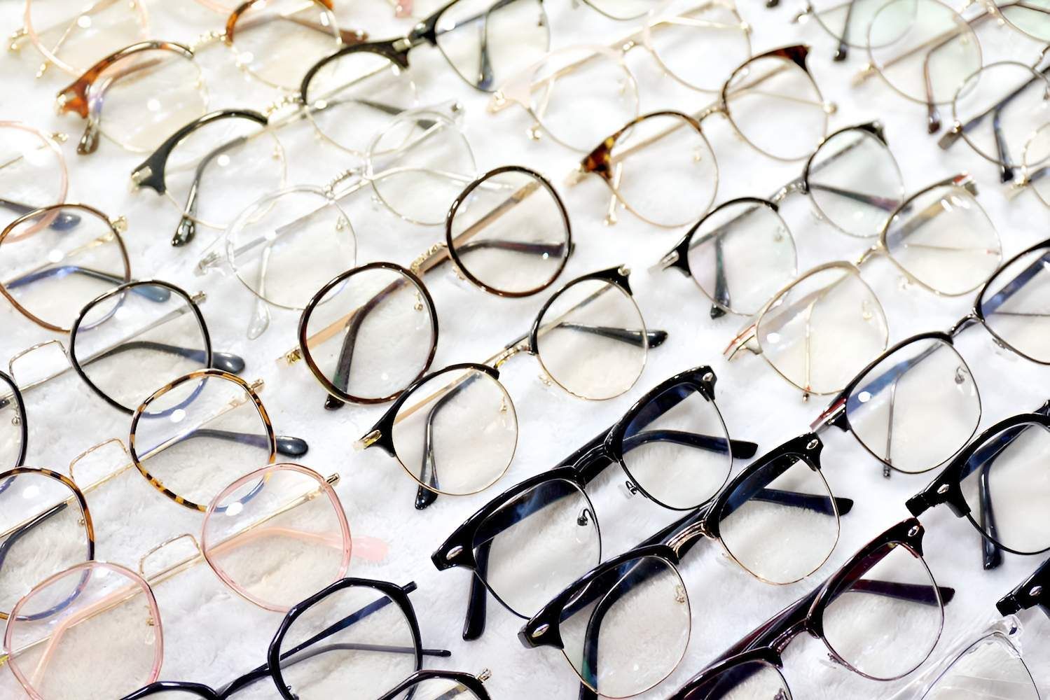 A Bunch Of Glasses Are Sitting On Top Of Each Other On A Table — Eye Supply In Mareeba, QLD