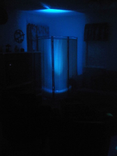 A room with a blue-lit screen. Dark setting.