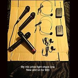Microphones and headsets on cardboard with text 