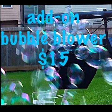 Bubble blower dispensing bubbles on a lawn, add-on service for $15.
