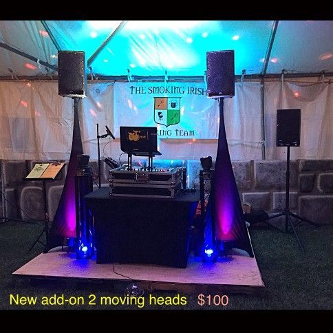 DJ setup with speakers, lighting, and a banner for 