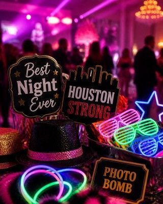 Party props with neon glasses and signs reading “Best Night Ever,” “Houston Strong,” and “Photo Bomb”