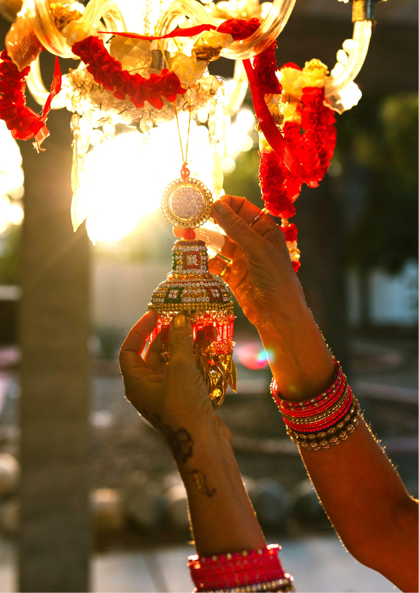 A woman with a tattoo on her arm is holding a lantern