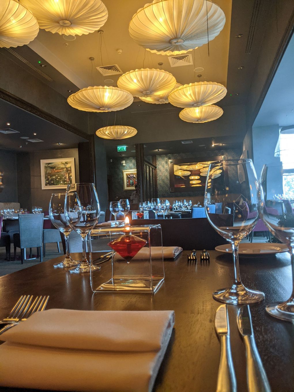 A restaurant with a lot of glasses on the table