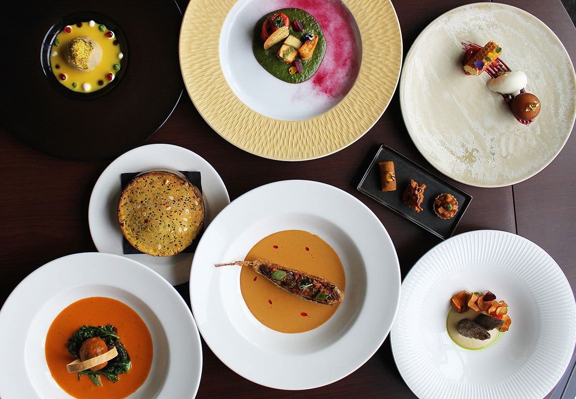 A table topped with a variety of plates of food