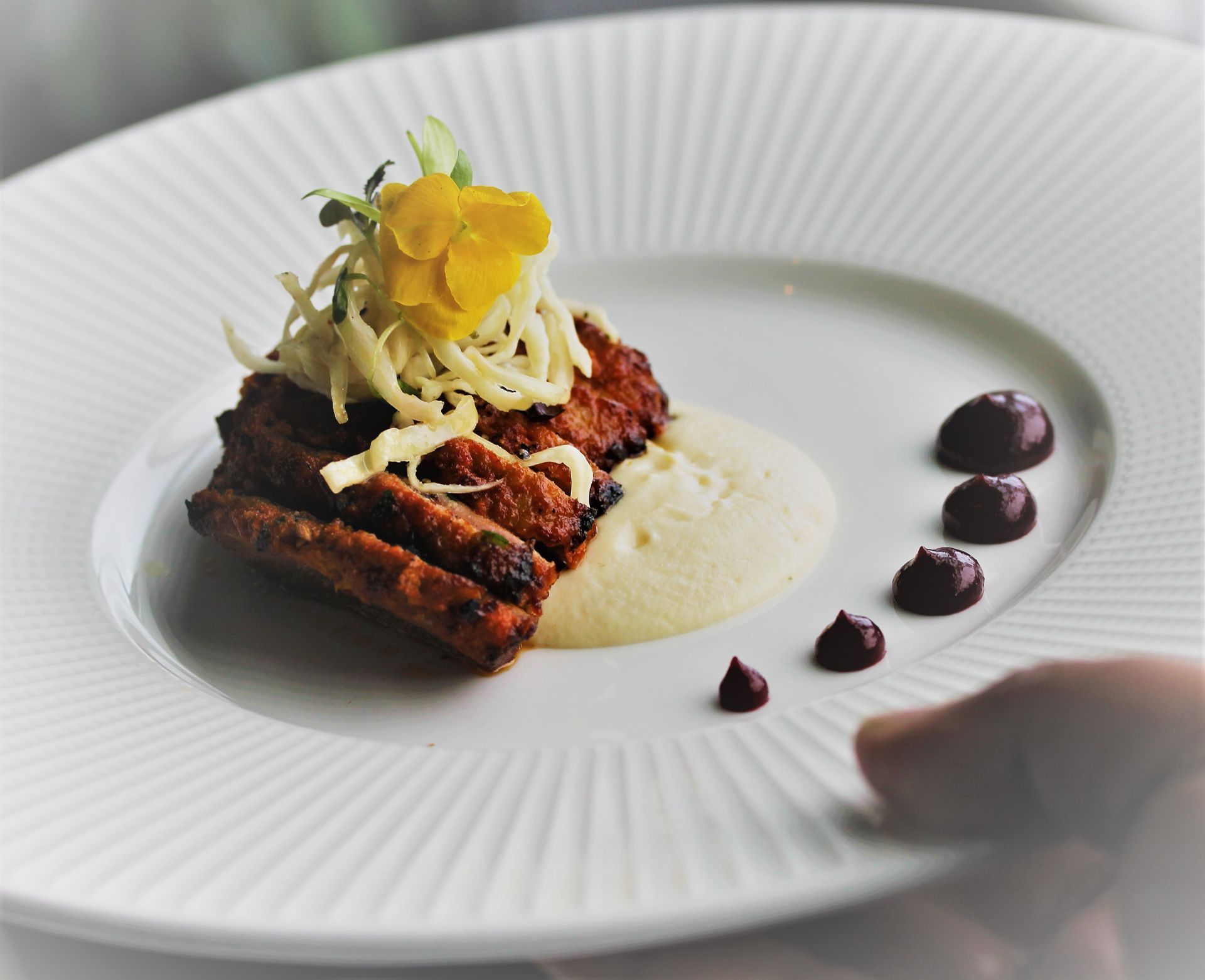 A white plate with a piece of food on it