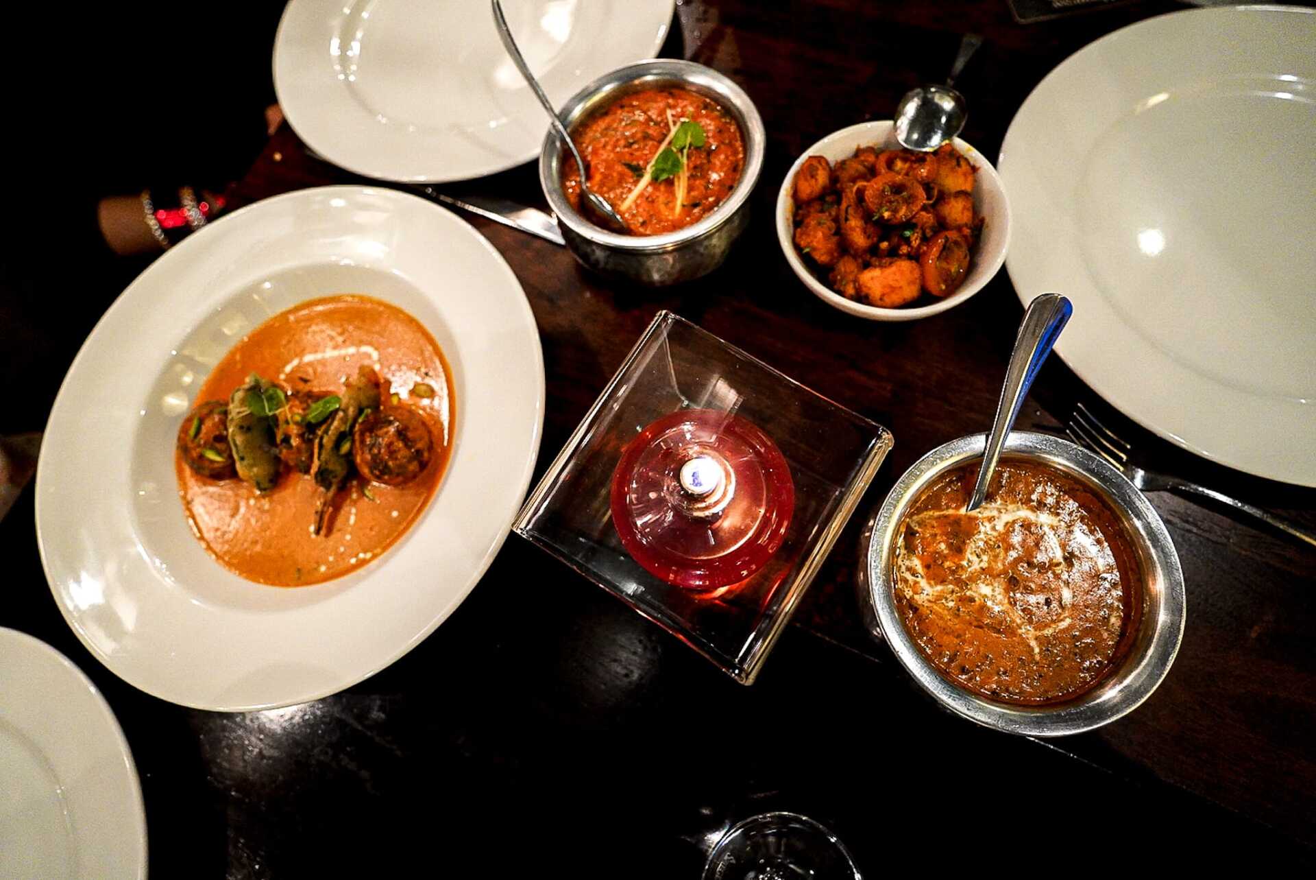 A table with plates and bowls of food on it