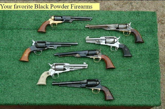 Several black powder firearms are displayed on a green mat