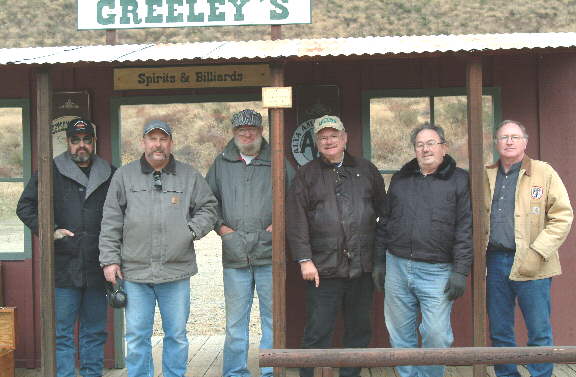 A group of men standing in front of greeley 's