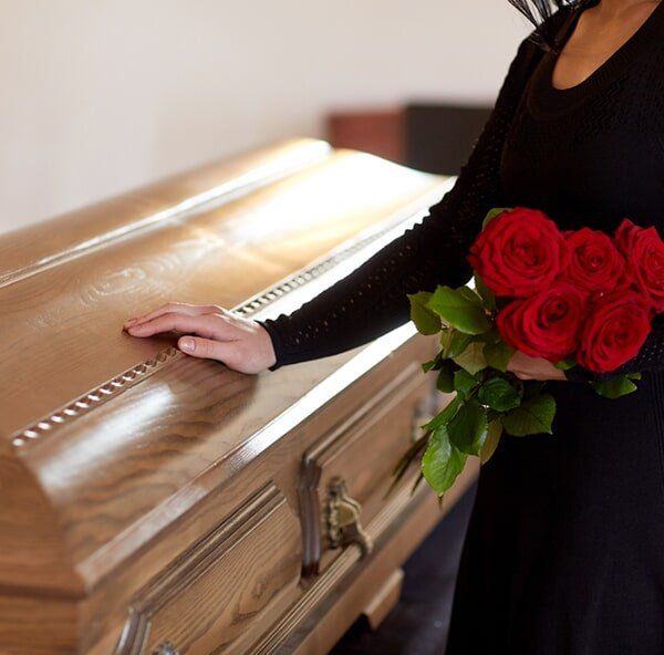 Red & White Flowers On The Coffin — Quality Cremation Services in Rockhampton, QLD