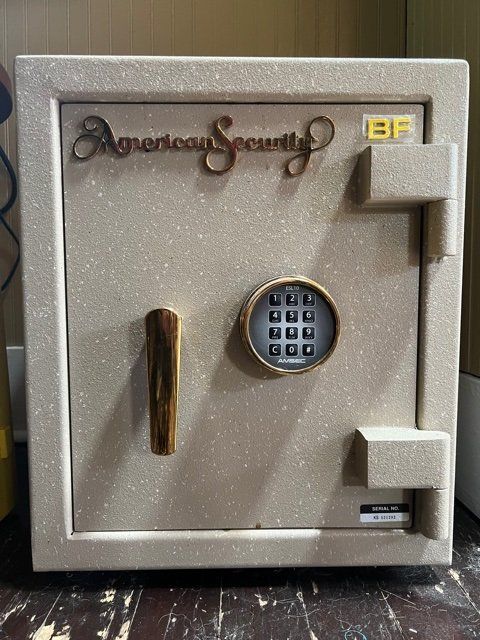 Decorative beige safe door with digital keypad and gold handle