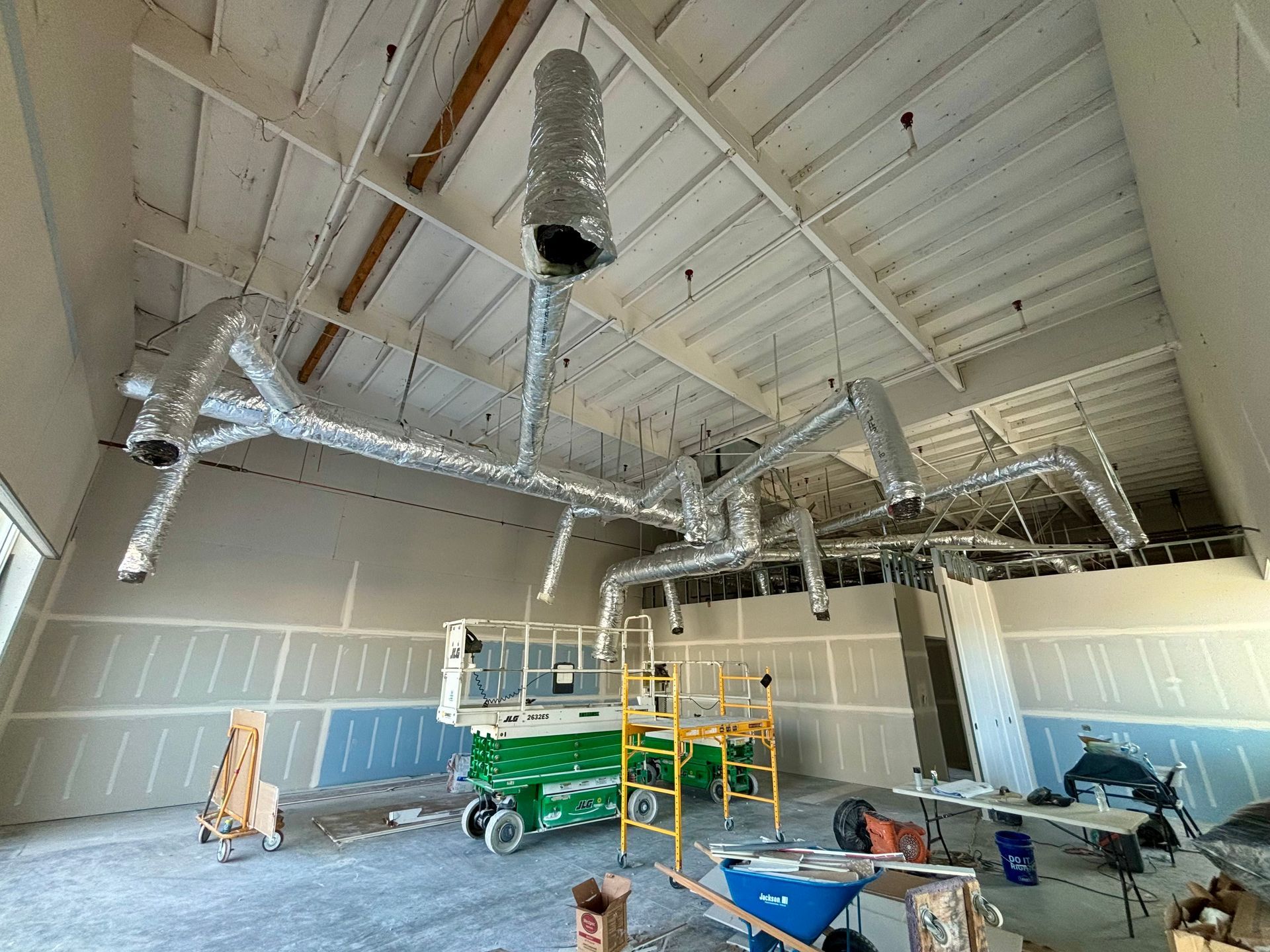 A large room with a lot of pipes hanging from the ceiling.
