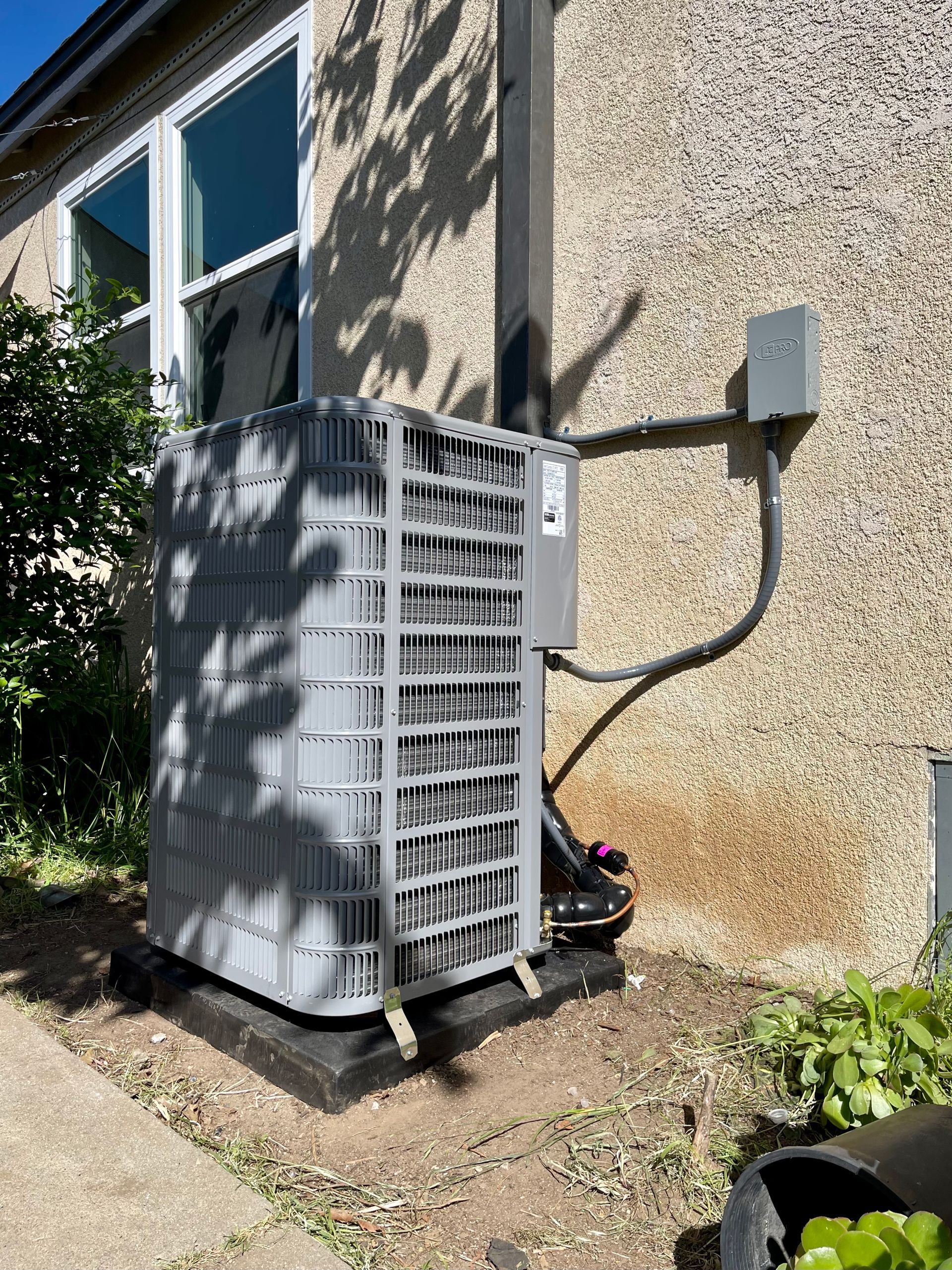 outdoor split system unit connected to the wall