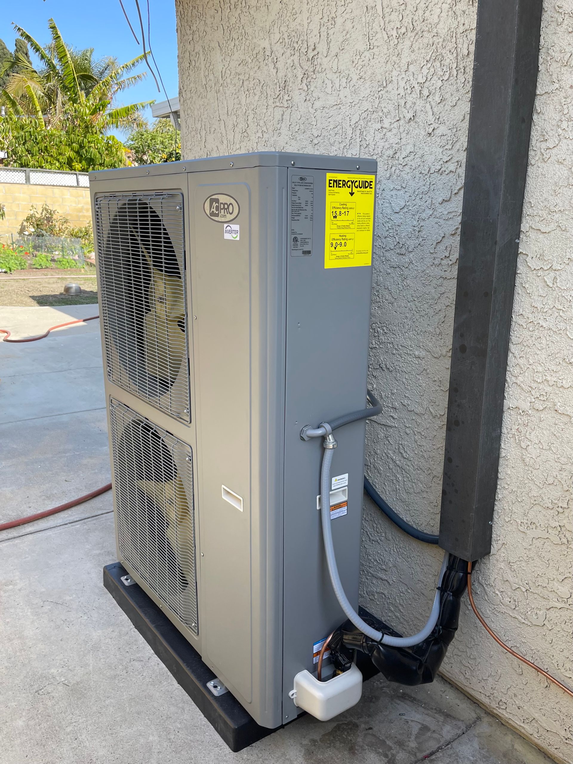 heat pump unit installed outdoors connected to the wall