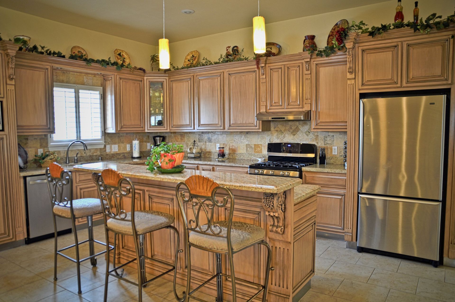 A kitchen with stainless steel appliances and wooden cabinets