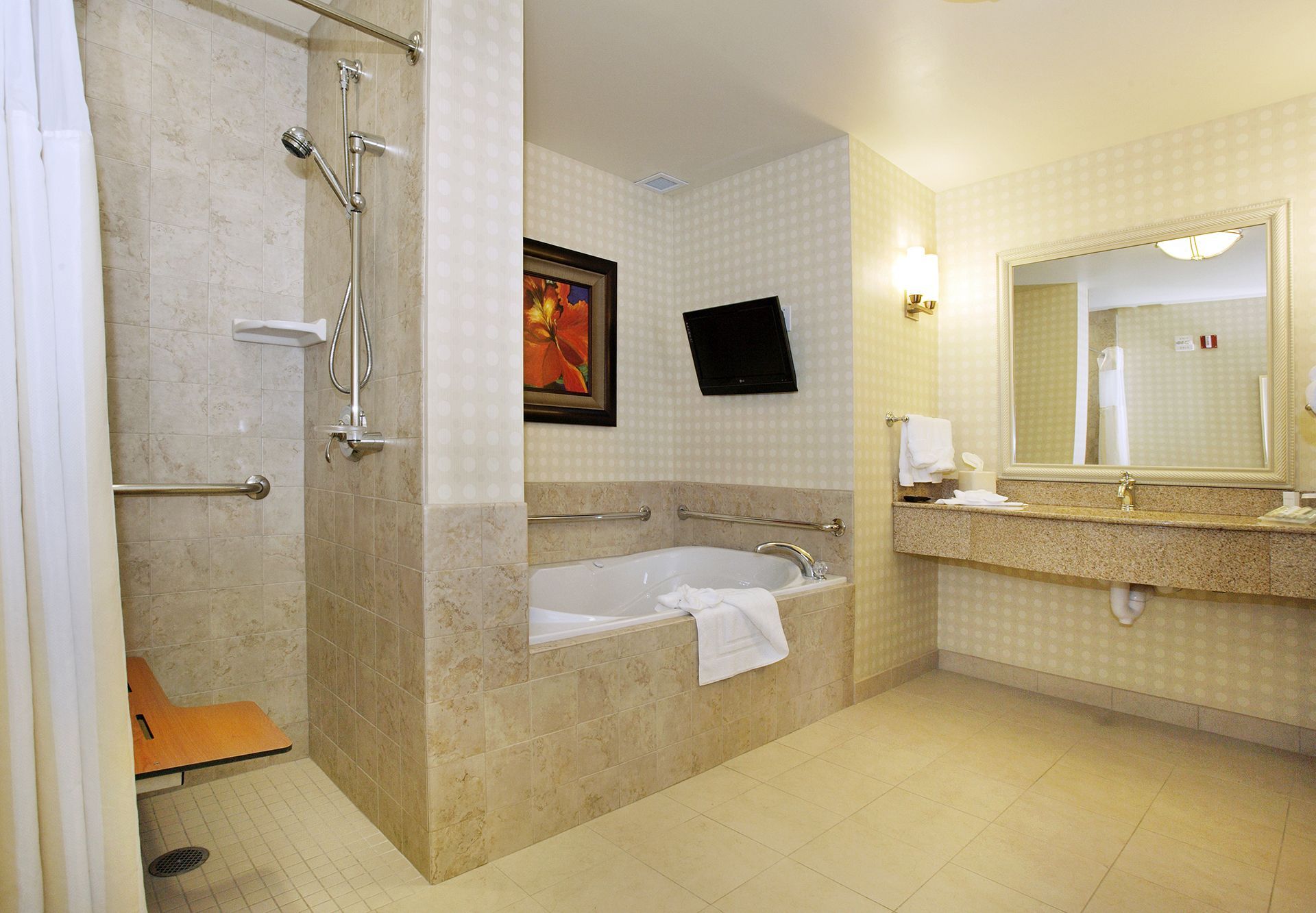 A bathroom with a tub , sink , and shower.