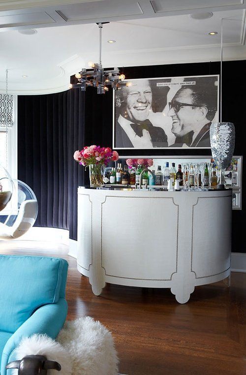 A living room with a bar and a picture on the wall