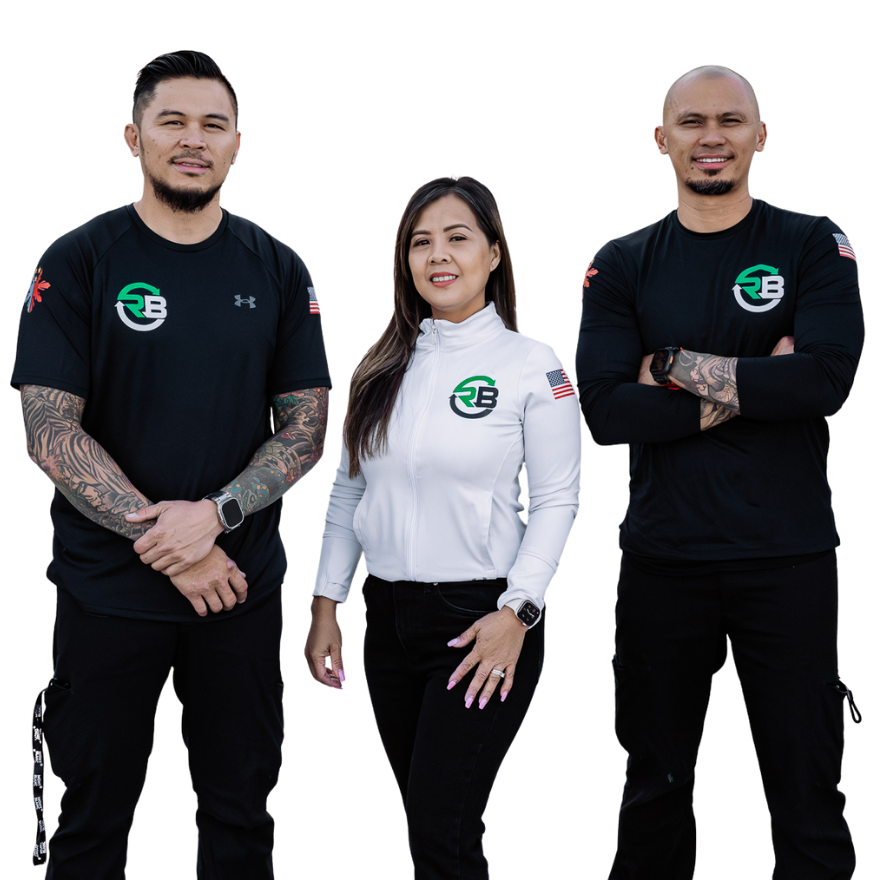 Three people posing against a white background, two in black tops and one in a white shirt.