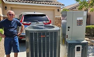 Technician beside outdoor HVAC units in a driveway, with a red SUV and garage in the background