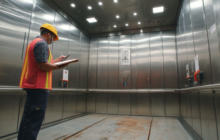 elevator technician monitoring load test in progress