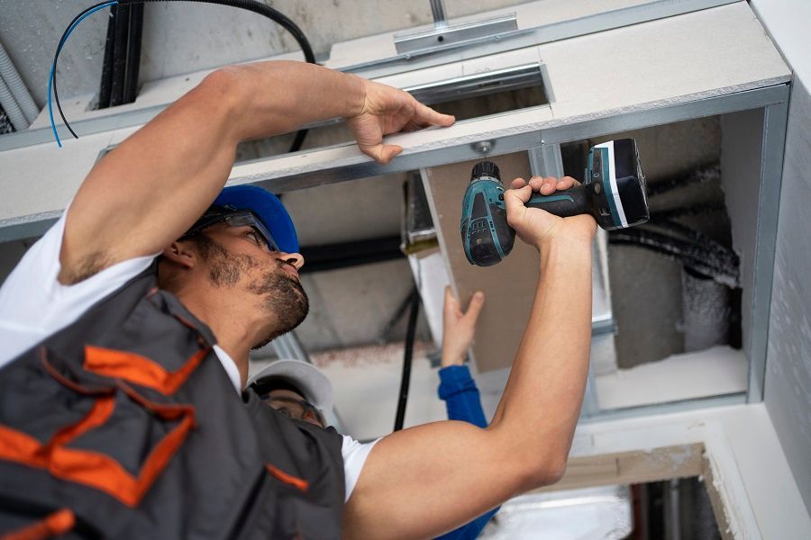 low angle man working with drill